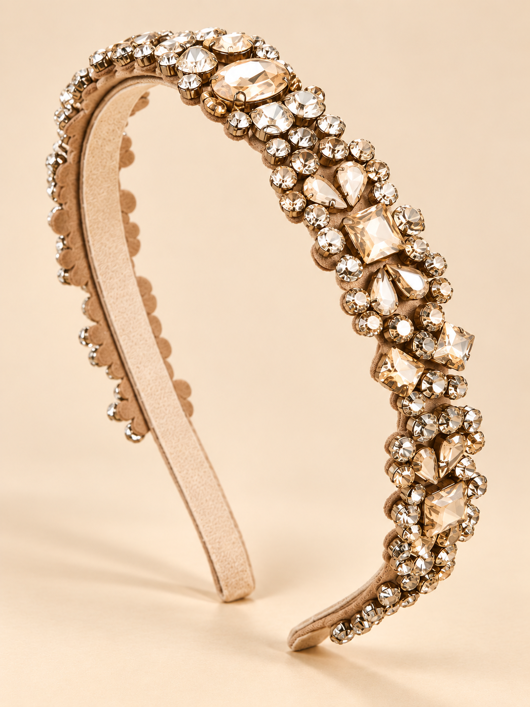 Luxe champagne haarband met kristallen op lichte beige achtergrond