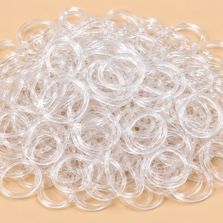 Transparante mini rubber bands 100 kleine haarelastiekjes op beige achtergrond | De HaarBoetiek