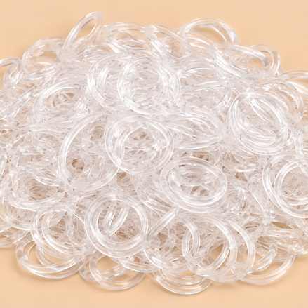 Transparante mini rubber bands 250 kleine haarelastiekjes op beige achtergrond | De HaarBoetiek