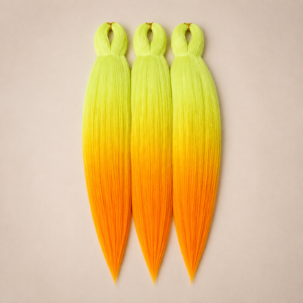 Citrus Crush 3-in-1 kanekalon invlechthaar Geel naar oranje op lichtbeige achtergrond