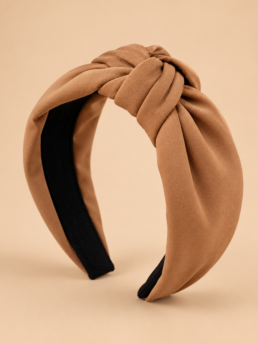Camel knoop haarband op egale beige achtergrond