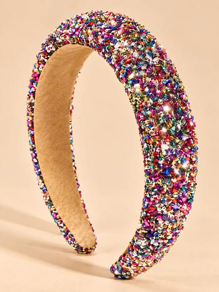 Brede multicolor glitter haarband met fonkelende kristallen op beige achtergrond